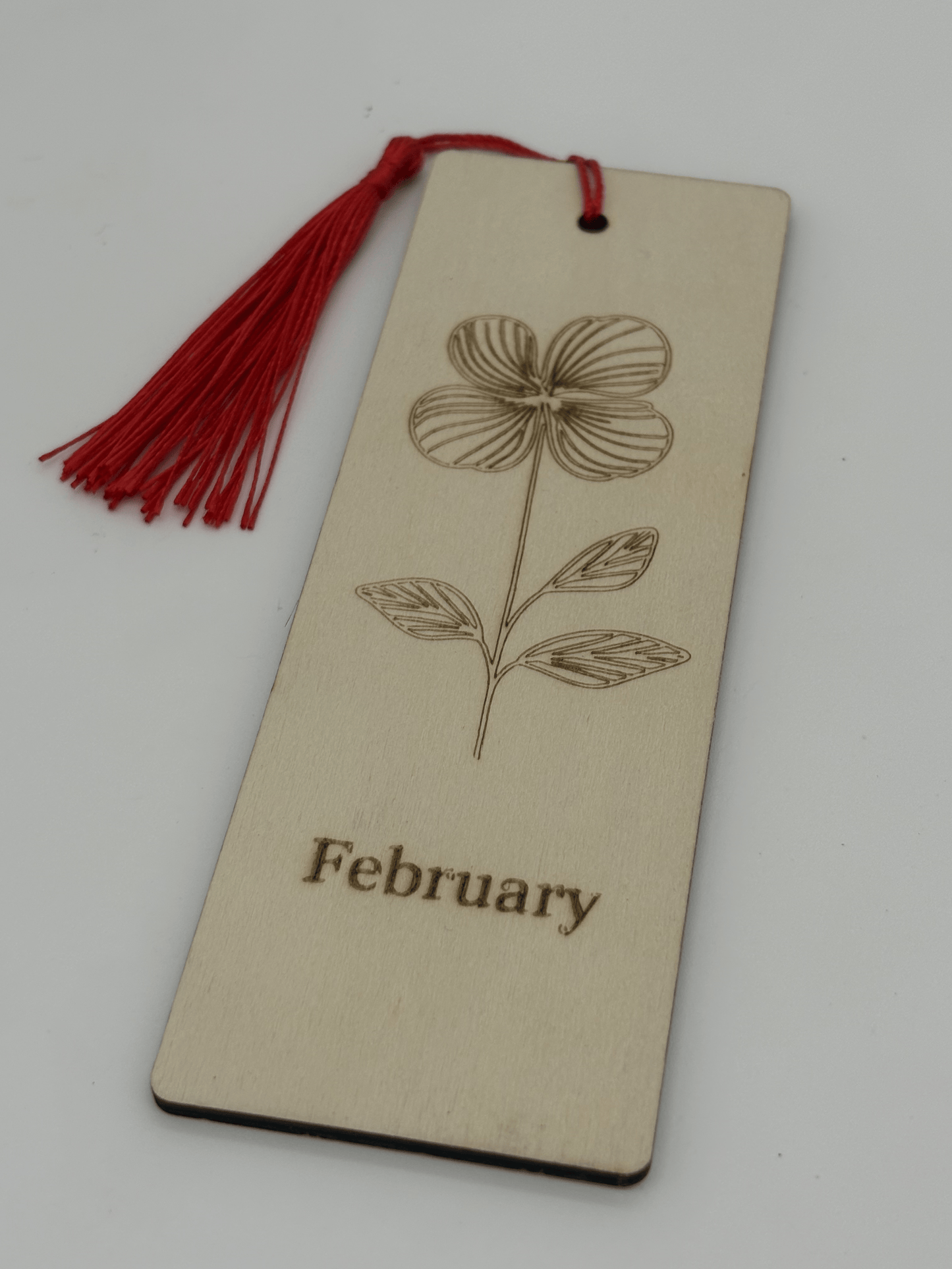 Bookmark with floral design and 'February' text on a beige background